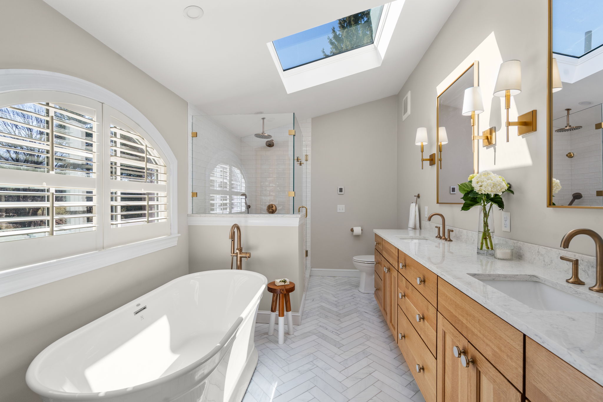Renovated bathroom in a MetroWest Massachusetts home with new tile shower, updated vanity, and fixtures installed by Masters Touch Design Build